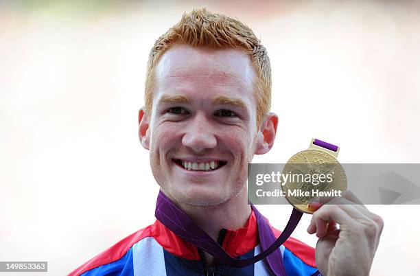 Gold medalist Greg Rutherford of Great Britain pose on the podium for Men's Long Jump on Day 9 of the London 2012 Olympic Games at the Olympic...