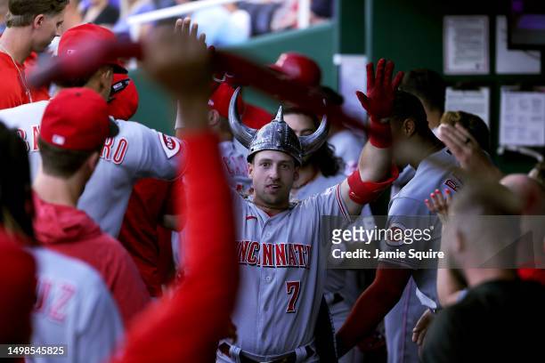 Spencer Steer of the Cincinnati Reds is congratulated by teammates in the dugout after hitting a home run during the 2nd inning of the game against...