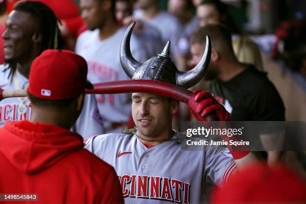 Spencer Steer of the Cincinnati Reds is congratulated by teammates in the dugout after hitting a home run during the 2nd inning of the game against...