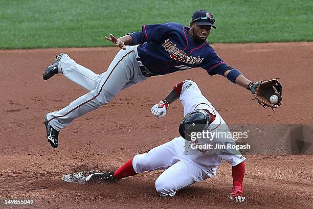 Carl Crawford of the Boston Red Sox steals second base as Alexi Casilla of the Minnesota Twins fields a high throw in the first inning at Fenway Park...