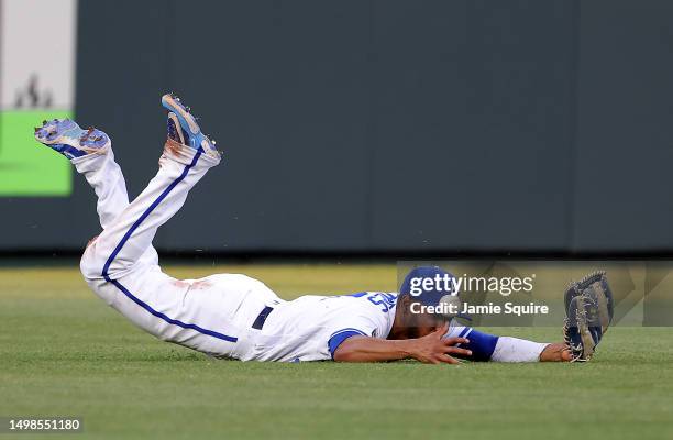 Edward Olivares of the Kansas City Royals dives for but misses the ball in the outfield during the 4th inning of the game against the Cincinnati Reds...