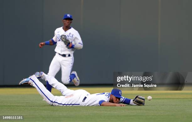 Edward Olivares of the Kansas City Royals dives for but misses the ball in the outfield during the 4th inning of the game against the Cincinnati Reds...