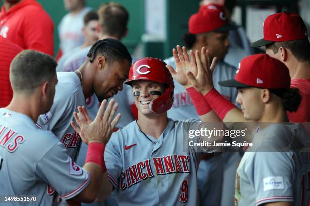 Matt McLain of the Cincinnati Reds is congratulated by teammates in the dugout after hitting a home run during the 4th inning of the game against the...