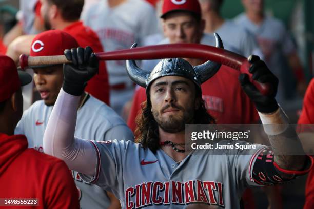 Jonathan India of the Cincinnati Reds is congratulated by teammates in the dugout after hitting a home run during the 5th inning of the game against...