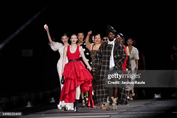 Karen Elson and Alton Mason walk the runway at the LuisaViaRoma & British Vogue "Runway Icons" show at Piazzale Michelangelo on June 14, 2023 in...