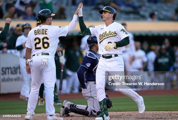 Bleday of the Oakland Athletics is congratulated by Jonah Bride after Bleday hit a three-run home run against the Tampa Bay Rays in the bottom of the...