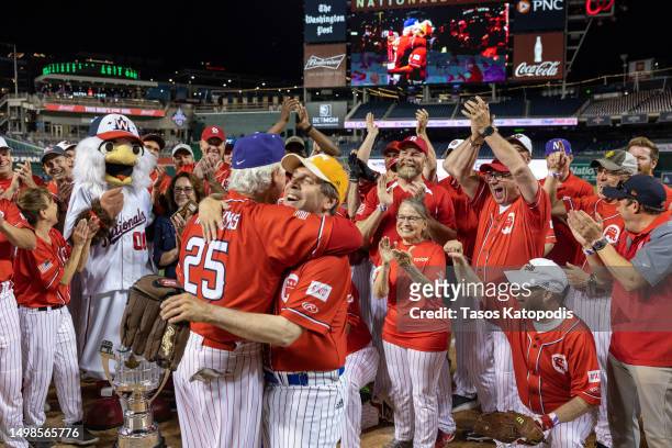 Republicans head coach Rep. Roger Williams celebrates with Rep. Chuck Fleischmann after wining the Congressional Baseball Game for Charity 16-6...