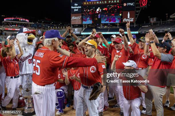Republicans head coach Rep. Roger Williams celebrates with Rep. Chuck Fleischmann after wining the Congressional Baseball Game for Charity 16-6...