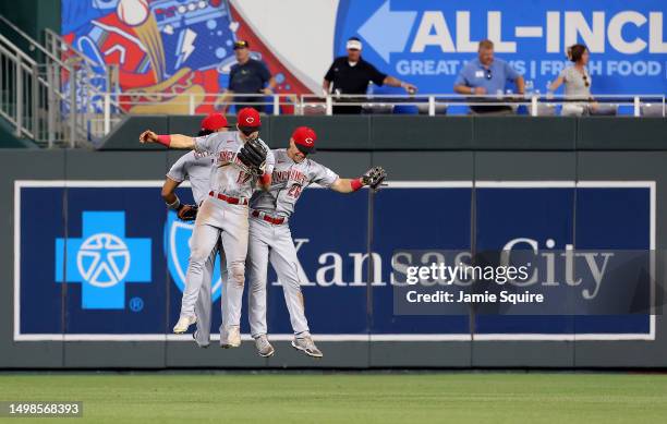 Outfielders Jose Barrero, Stuart Fairchild and T.J. Hopkins of the Cincinnati Reds celebrate after the reds defeated the Kansas City Royals 7-4 to...