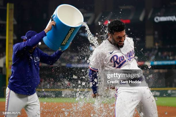 Marcus Semien of the Texas Rangers is doused with water by Martin Perez after the game against the Los Angeles Angels at Globe Life Field on June 14,...