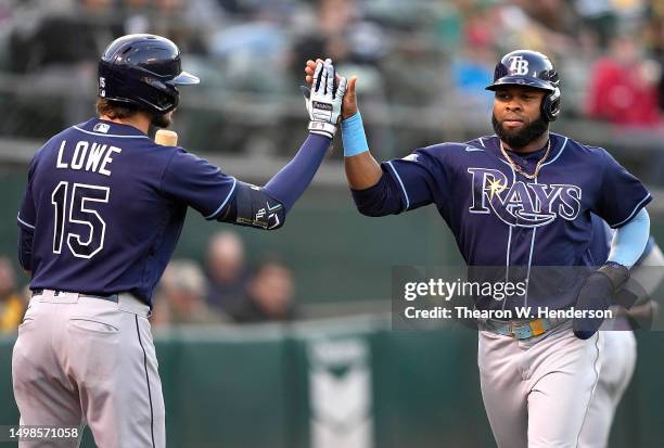 Manuel Margot of the Tampa Bay Rays is congratulated by Josh Lowe after Margot scored against the Oakland Athletics in the top of the fifth inning at...