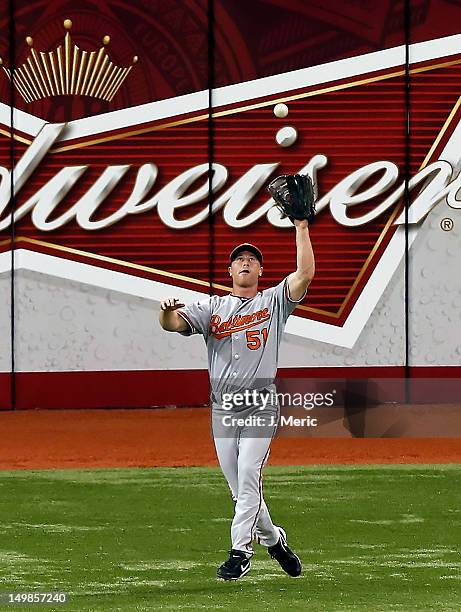 Outfielder Lew Ford of the Baltimore Orioles catches a fly ball against the Tampa Bay Rays during the game at Tropicana Field on August 5, 2012 in...