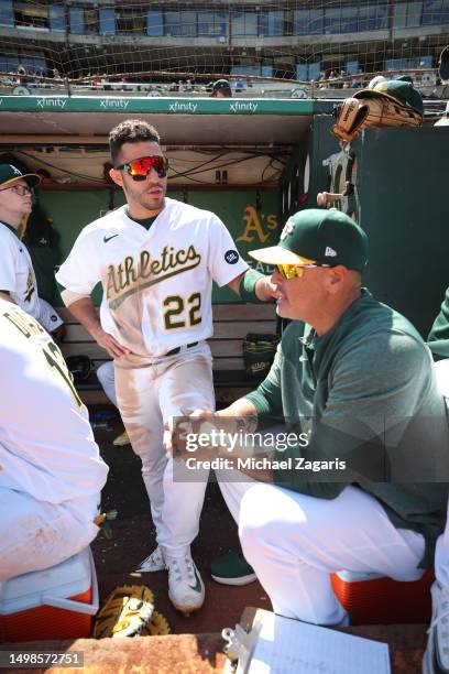 Ramon Laureano and Major League Staff Assistant Ramon Hernandez of the Oakland Athletics in the dugout during the game against the Houston Astros at...