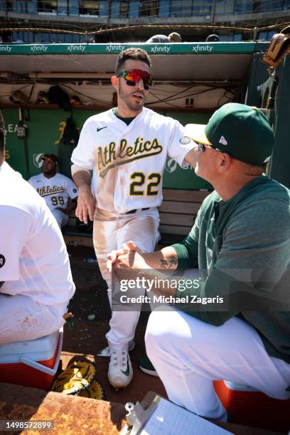 Ramon Laureano and Major League Staff Assistant Ramon Hernandez of the Oakland Athletics in the dugout during the game against the Houston Astros at...