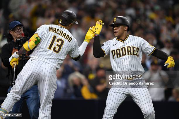 Juan Soto of the San Diego Padres is congratulated by Manny Machado after hitting a home run against the Cleveland Guardians during the sixth inning...
