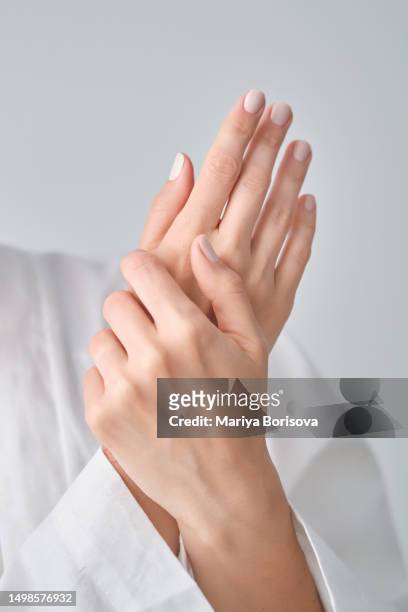 well-groomed female hands with manicure. - nagelhaut stock-fotos und bilder