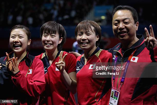 Ai Fukuhara, Kasumi Ishikawa, Sayaka Hirano and coach of Japan Yasukazu Murakami celebrate after winning Women's Team Table Tennis semifinal match...