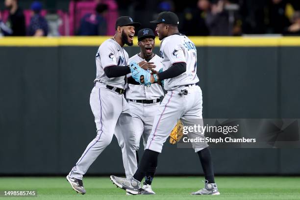 Bryan De La Cruz, Jonathan Davis and Jesus Sanchez of the Miami Marlins celebrate their 4-1 win against the Seattle Mariners at T-Mobile Park on June...