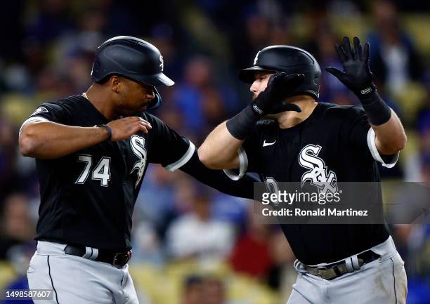 Jake Burger of the Chicago White Sox celebrates a two-run home run with Eloy Jimenez against the Los Angeles Dodgers in the eighth inning at Dodger...