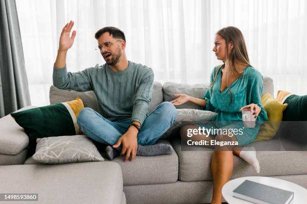 shot of a young couple having an argument at home - annoyed girlfriend stock pictures, royalty-free photos & images