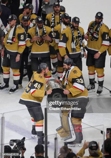 Ivan Barbashev of the Vegas Golden Knights hands the Stanley Cup to teammate Adin Hill after the team's 9-3 victory over the Florida Panthers in Game...