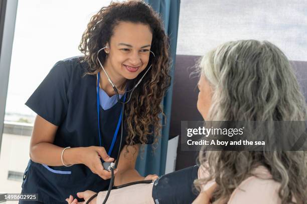 kind looking female doctor with patient - kindness stock pictures, royalty-free photos & images