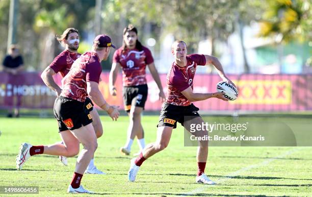 Daly Cherry-Evans passes the ball to Thomas Flegler during a Queensland Maroons State of Origin training session at Sanctuary Cove on June 15, 2023...