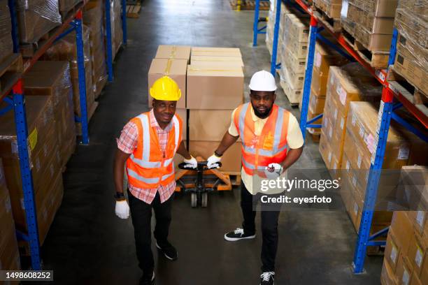 blue collar worker work at warehouse. - man pulling collar stock pictures, royalty-free photos & images