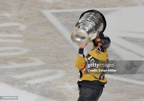 Nicolas Roy of the Vegas Golden Knights hoists the Stanley Cup after the team's 9-3 victory over the Florida Panthers in Game Five of the 2023 NHL...