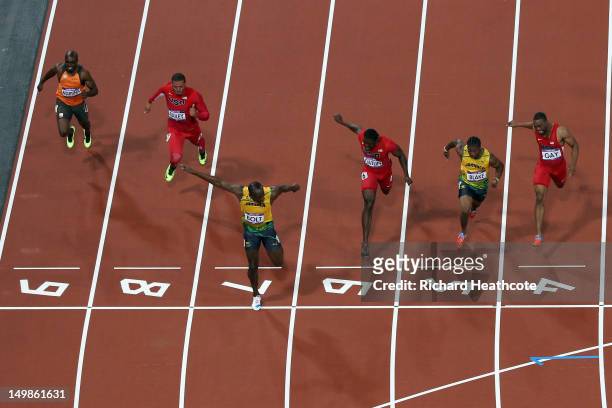 Usain Bolt of Jamaica crosses the finish line ahead of Ryan Bailey of the United States, Yohan Blake of Jamaica and Justin Gatlin of the United...