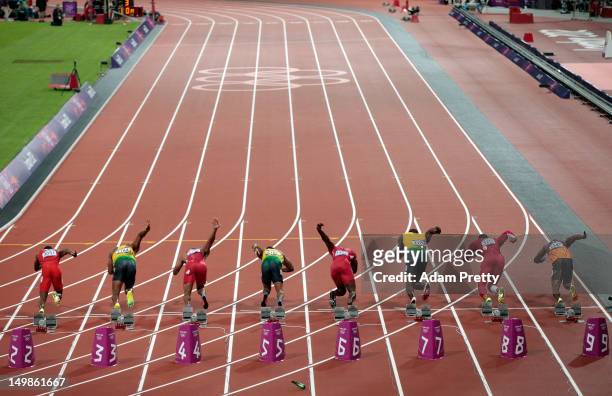 Runners leave the starters block to start the Men's 100m Final on Day 9 of the London 2012 Olympic Games at the Olympic Stadium on August 5, 2012 in...