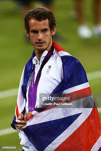 Andy Murray of Great Britain poses with his gold and silver medals holding a union jack after the medal ceremony for the Mixed Doubles Tennis on Day...