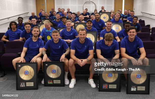 Players pose for a photograph following a presentation by Harry Kane, who gave his England team-mates a special gift for their part in Kane’s...