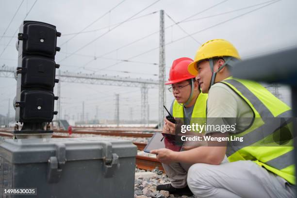 worker checking railway traffic lights - railway signal stock pictures, royalty-free photos & images