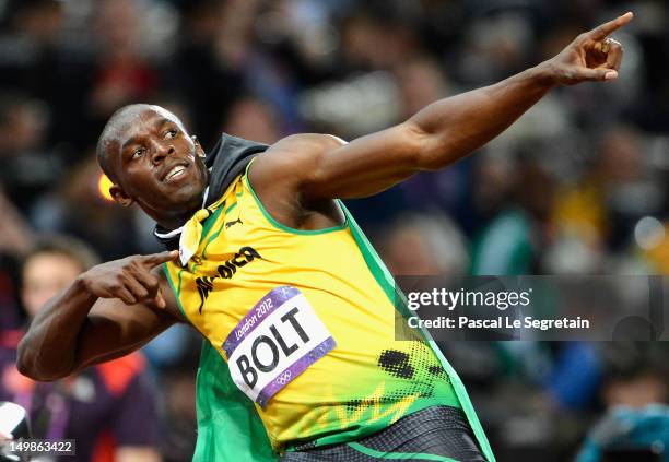 Usain Bolt of Jamaica celebrates after crossing the finish line to win the gold medal in the Men's 100m Final on Day 9 of the London 2012 Olympic...