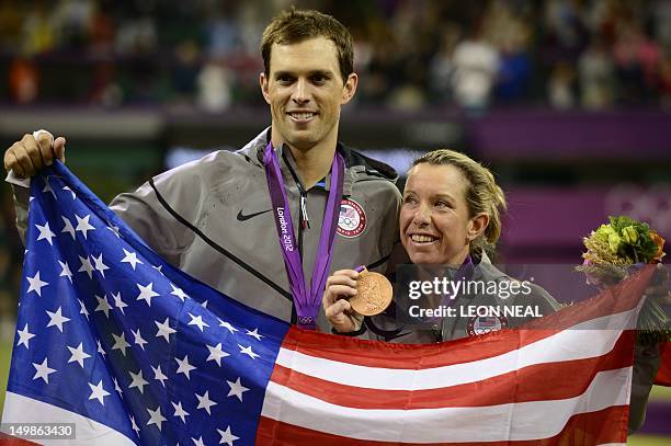 Lisa Raymond and Mike Bryan display their bronze medals during a ceremony at the end of the London 2012 Olympic Games mixed doubles tennis...