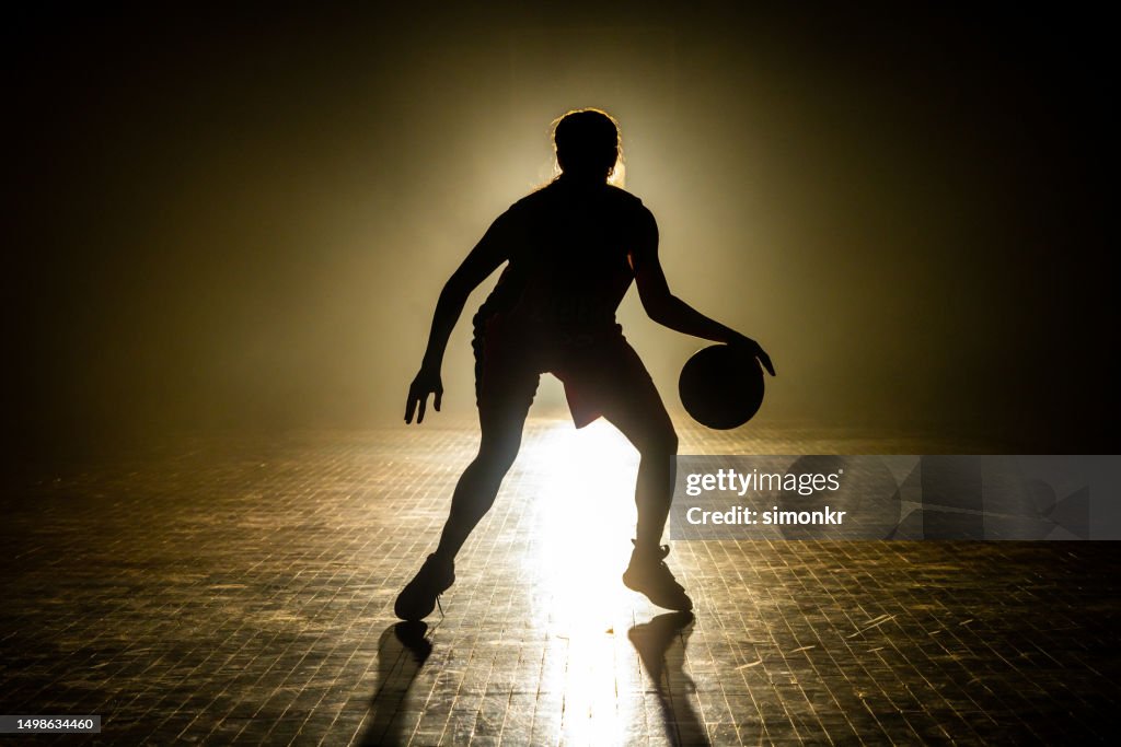 Basketball player dribbling ball