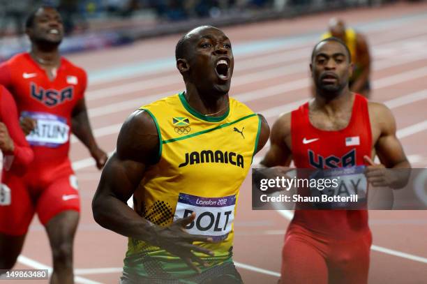 Usain Bolt of Jamaica crosses the finish line ahead of of Ryan Bailey of the United States and Justin Gatlin of the United States to win the Men's...