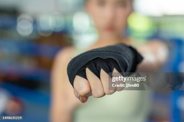 empowered asian female boxer. solo strength in the spotlight - protective sportswear stock pictures, royalty-free photos & images