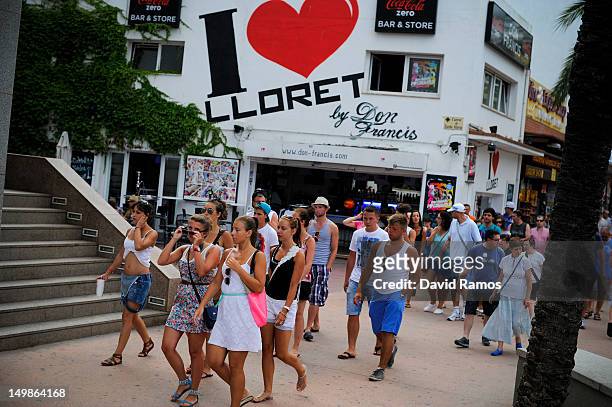 Tourists walks along the main commercial street on August 5, 2012 in Lloret de Mar, Spain. Tourism is the largest contributor to the welfare of...