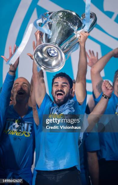 Ilkay Gundogan of Manchester City celebrates with the Champions League trophy on stage in St Peter's Square during the Manchester City trophy parade...