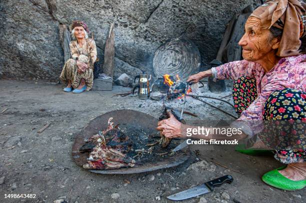 peasant woman ironing goat hair - fire victim stock pictures, royalty-free photos & images