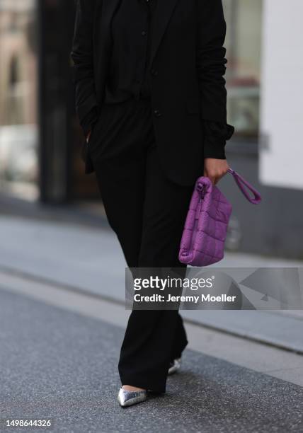 Marlene Fey wearing purple VeeCollective bag, silver Celine heels, black SoSue suit on June 08, 2023 in Hamburg, Germany.