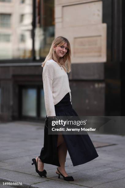 Tabea Heidenreich wearing beige oversized SoSue sweater, black long Sosue skirt with slit, black small Chanel bag with golden chain, black Zara heels...