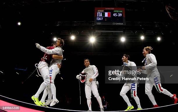 Andrea Baldini of Italy and his teammates celebrate defeating Yuki Ota of Japan to win the gold medal match 45-39 in the Men's Foil Team Fencing...