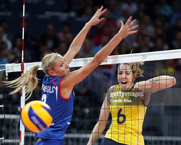 Thaisa Menezes of Brazil spikes the ball past Ivana Djerisilo of Serbia during Women's Volleyball on Day 9 of the London 2012 Olympic Games at Earls...
