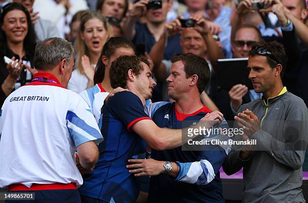 Andy Murray of Great Britain hugs his former coach and Davis Cup captian Leon Smith after defeating Roger Federer of Switzerland in the Men's Singles...