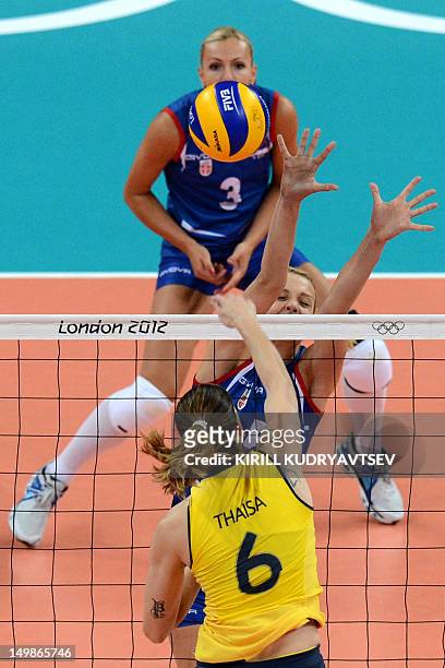 Brazil's Thaisa Menezes spikes as Serbia's Natasa Krsmanovic attempts to block during their London 2012 Olympic Games women's preliminary pool B...