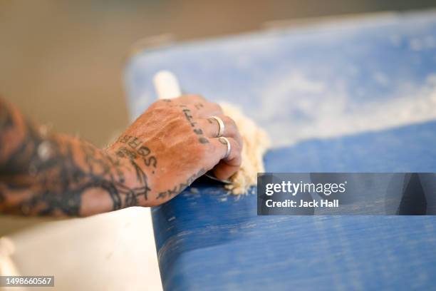 General view of a trainee at work during Ashley Walters visit to The Dusty Knuckle bakery ahead of their youth fundraiser event to raise money for...