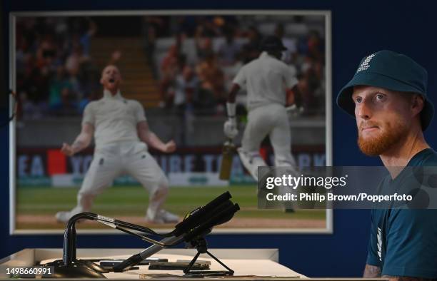 Ben Stokes of England looks on in a press conference in front of a photograph of him celebrating a dismissal before the First Ashes Test between...